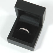 detailed shot of a wedding band in a premium black ring box