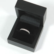 detailed shot of a wedding band in a premium black ring box 