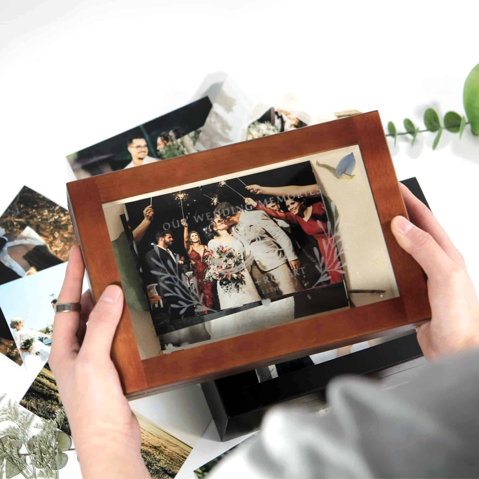 photo storage box with engraved cover holding wedding photographs