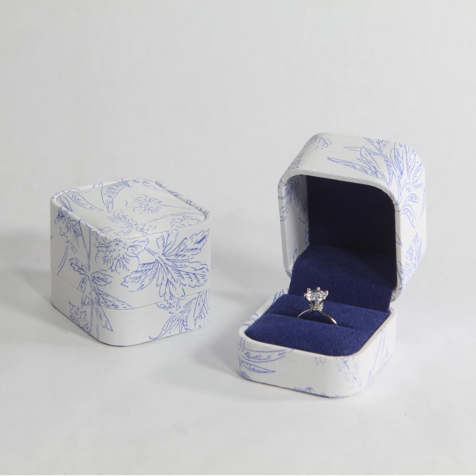 white and blue velvet ring box with ring
