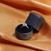black engagement ring box for proposals on orange satin background