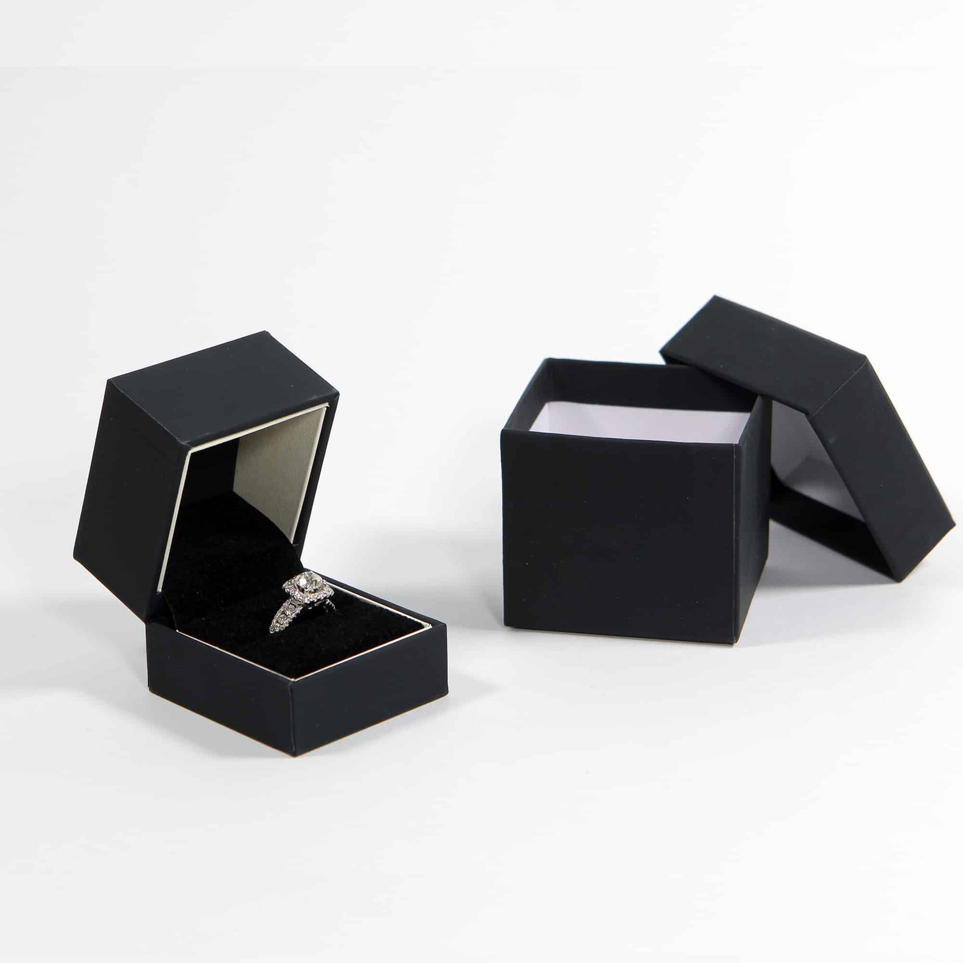black ring box for proposal with white stripe with diamond ring in the box
