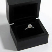 Black ring box with diamond engagement ring, closeup photo of black wood ring box