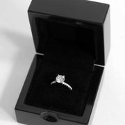 shiny gloss black ring box with black velvet interior and diamond engagement ring inside