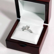 closeup of diamond proposal ring in a classic rosewood ring box with white leather 